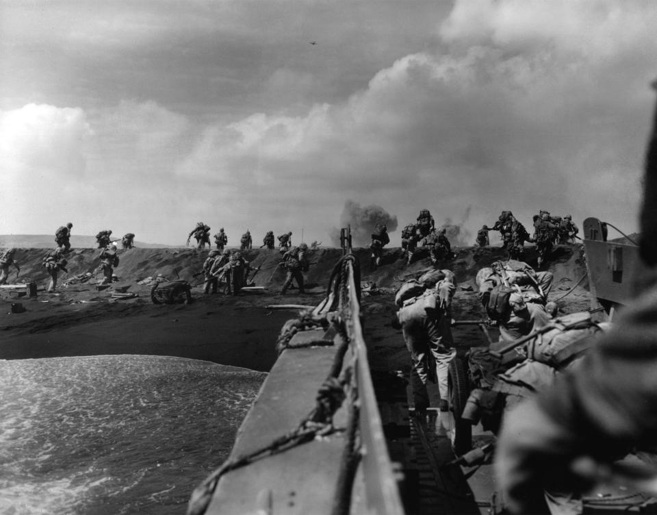 In the Pacific theater of World War II, U.S. Marines hit the beach and charge over a dune on Iwo Jima in the Volcano Islands Feb. 19, 1945, the start of one of the deadliest battles of the war against Japan.