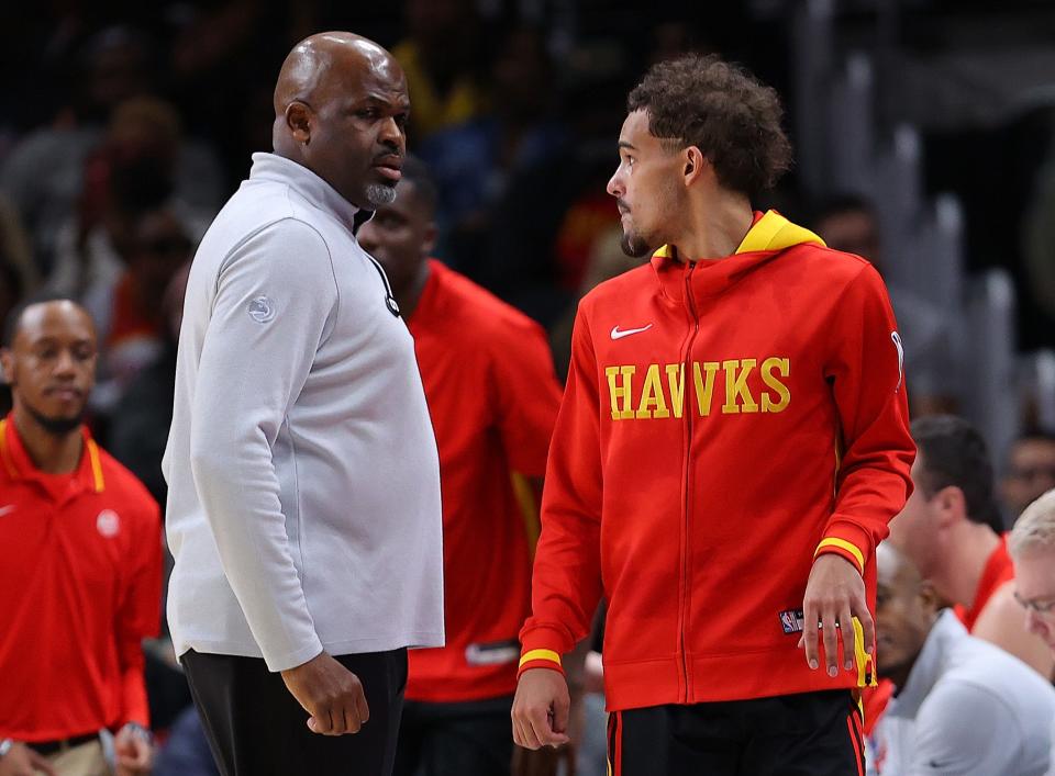 Nate McMillan and Trae Young during a game in December 2022.