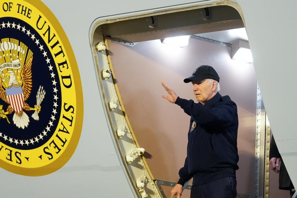 Joe Biden waves as he walks down the steps of Air Force One at Dover Air Force Base in Delaware on Wednesday (AP)