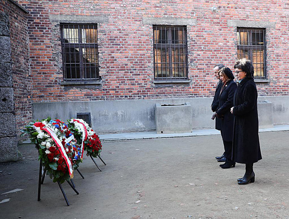 In this image provided by the US Consulate General in Krakow, U.S. House Speaker Nancy Pelosi, center, and speakers of Poland's parliament lay wreaths at the executions Death Wall of the World War II Nazi death camp of Auschwitz-Birkenau during a visit to the site of the former camp just days before the 75th anniversary of its 1945 liberation by the Soviet troops, at the Auschwitz-Birkenau Museum, in southern Poland, on Tuesday, Jan. 21, 2020. (US Consulate General in Krakow via AP)