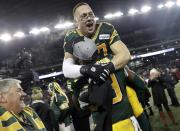 Edmonton Eskimos' JC Sherritt is hoisted in the air by teammate Willie Jefferson after the Eskimos defeated the Ottawa Redblacks in the CFL's 103rd Grey Cup championship football game in Winnipeg, Manitoba, November 29, 2015. REUTERS/Lyle Stafford