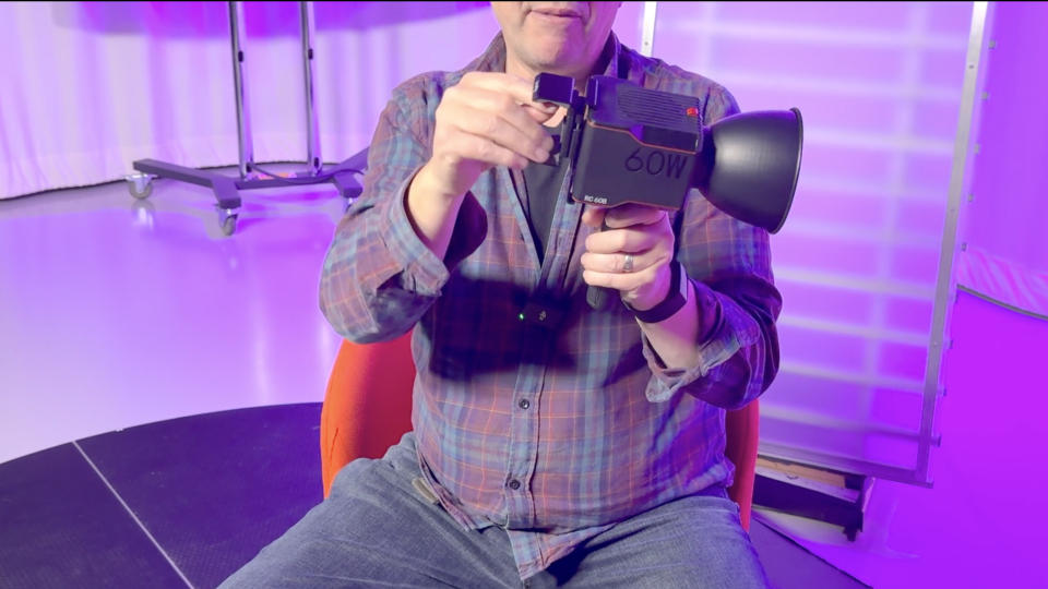 Man holding a SmallRig RC 60B COB video light