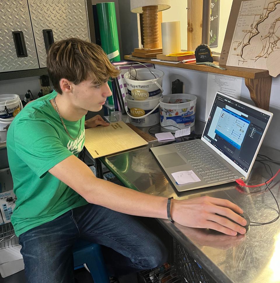 Jaxin sets up a laser engraver in the Washington Island School District's existing fabrication laboratory, or "fab lab." The district recently received a $25,000 grant from the Wisconsin Economic Development Corp. to expand its fab lab.