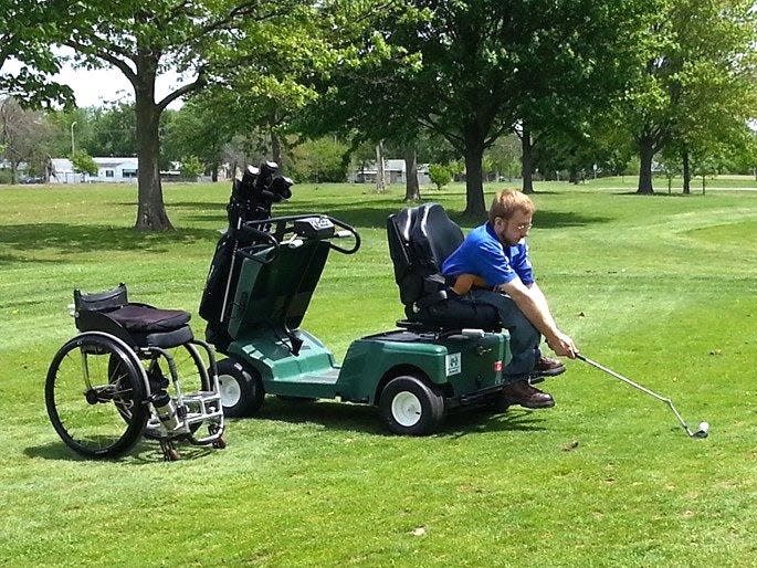 Wheelchair user Kevin Hughes swings from an adaptive cart on a golf course in Fort Wayne, Indiana to show how the sport can be made accessible.