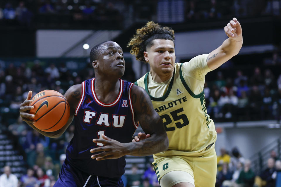 Florida Atlantic guard Johnell Davis, left, drives against Charlotte guard Lu'Cye Patterson, right, during the second half of an NCAA college basketball game in Charlotte, N.C., Saturday, Jan. 6, 2024. (AP Photo/Nell Redmond)