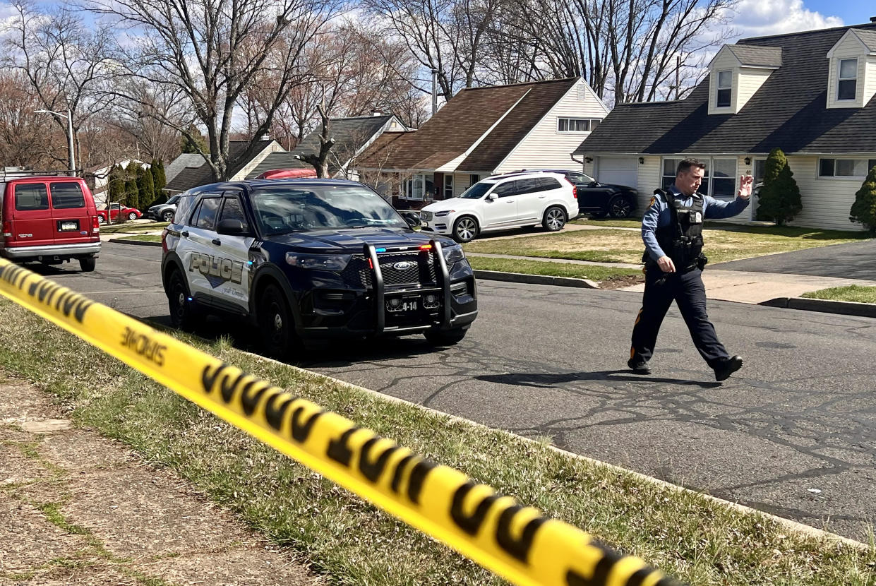 A police officer patrols a neighborhood during an active shooter situation in Levittown, a community within Falls Township, Pennsylvania, where a shelter-in-place order was issued on March 16, 2024.  / Credit: JOE LAMBERTI/AFP via Getty Images