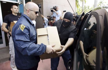 FBI agents bring out boxes after an operation inside the CONCACAF (Confederation of North, Central America and Caribbean Association Football) offices in Miami Beach, Florida May 27, 2015. REUTERS/Javier Galeano