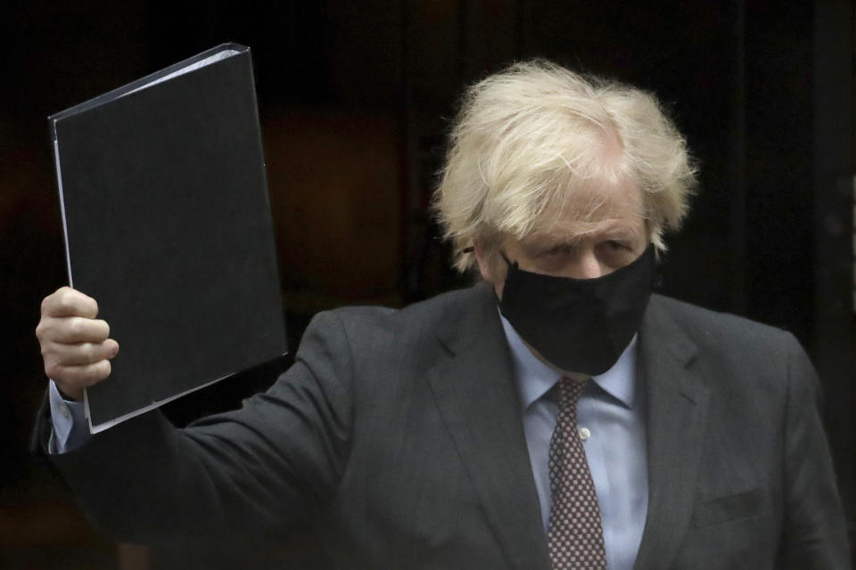 British Prime Minister Boris Johnson leaves 10 Downing Street to go to the Houses of Parliament, in London, Monday, Feb. 22, 2021. Johnson on Monday is expected to announce a plan to ease coronavirus restrictions in increments, starting by reopening schools in England on March 8. (AP Photo/Matt Dunham)