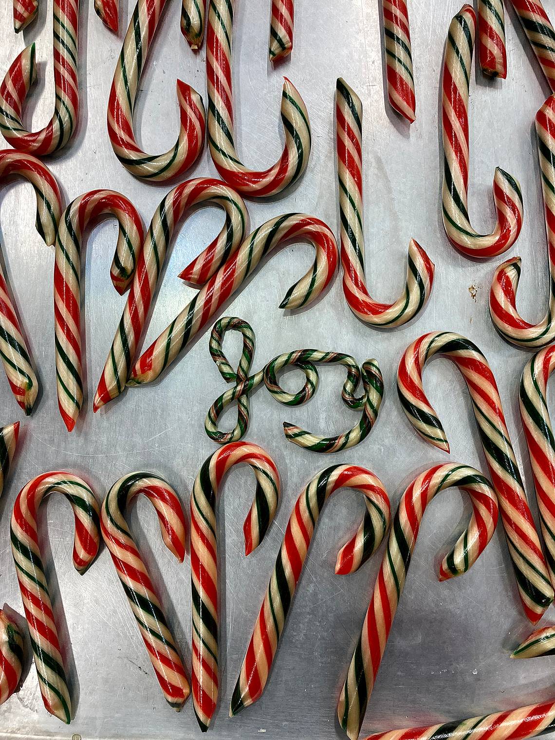 Peter Vrinios makes candy canes atop his family’s antique candy table at the Fudge Factory in Bradenton Beach. Vrinios’ family has been making candy for four generations and has been putting on a candy show during the holidays.