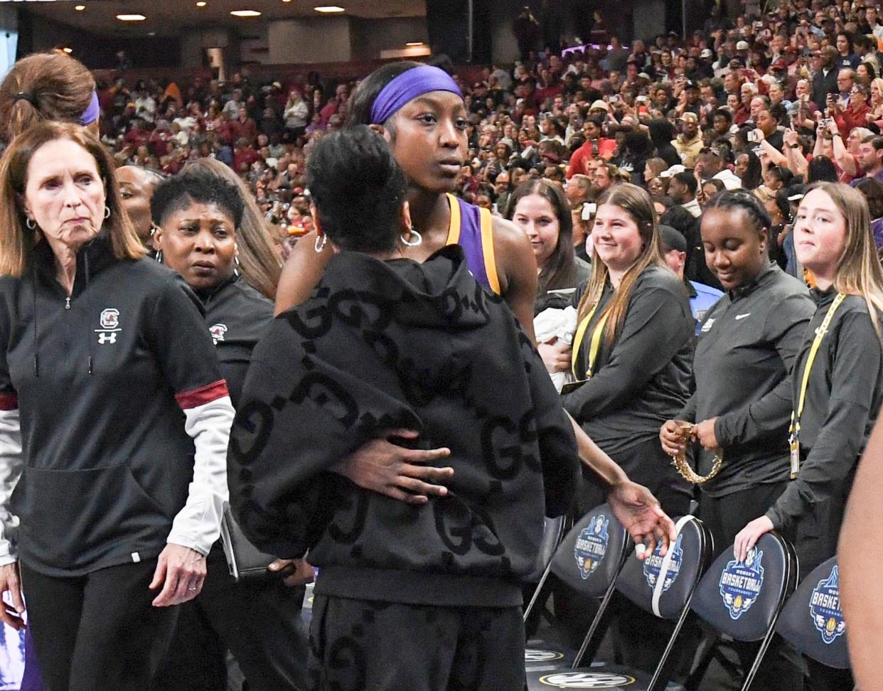 LSU guard Flau'jae Johnson hugs South Carolina coach Dqwn Staley after South Carolina's win in the SEC tournament title game in Greenville, S.C., on Sunday. Johnson was shoved to the ground by South Carolina player Kamilla Cardoso during a fourth-quarter scrum. Cardoso will have to sit out South Carolina's NCAA opener after her ejection for fighting.