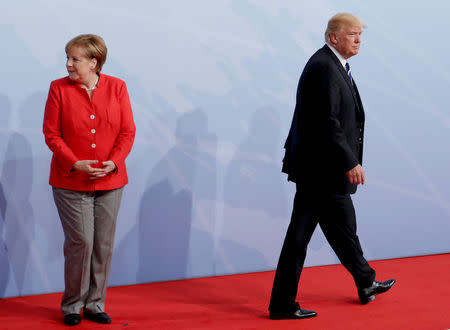 FILE PHOTO: German Chancellor Angela Merkel welcomes U.S. President Donald Trump to the opening day of the G20 leaders summit in Hamburg, Germany, July 7, 2017. REUTERS/Ian Langsdon/Pool/File Photo