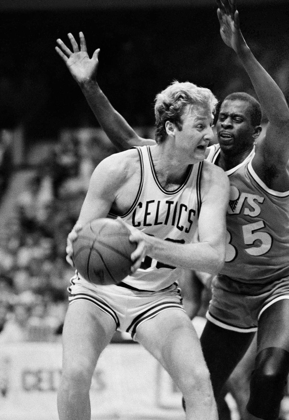Celtics forward Larry Bird, left, looks to make a play as Cavaliers forward Phil Hubbard defends late in the fourth quarter of Game 1 of a first-round NBA playoff series, Thursday, April 19, 1985, at Boston Garden.
