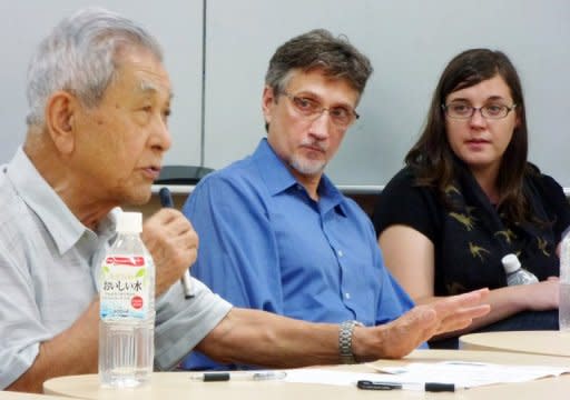 Clifton Truman Daniel (centre), a grandson of former US president Harry Truman who authorised the atomic bomb drops 67 years ago, looks at Hiroshima survivor Nobuo Miyake (left), 83, as he speaks at a symposium at the University of Tokyo on August 3. Daniel met survivors in Tokyo Friday, calling it "a good first step towards healing old wounds"