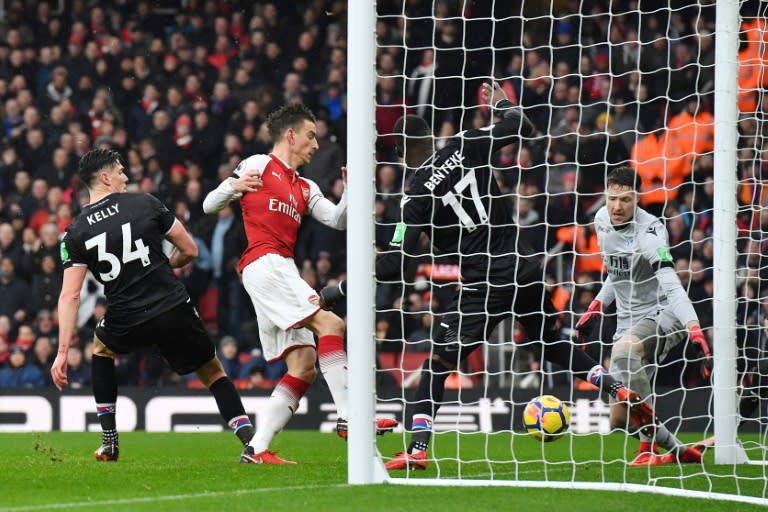 Arsenal's defender Laurent Koscielny (2L) shoots and scores their third goal during the English Premier League football match against Crystal Palace January 20, 2018