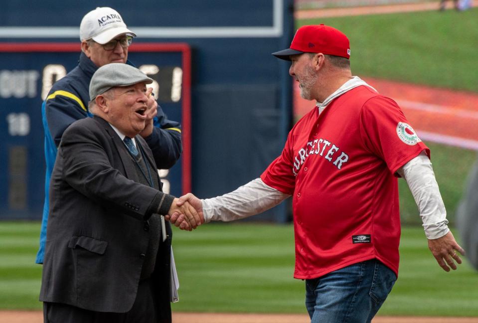 WooSox president Dr. Charles Steinberg welcomes former Boston Red Sox star Trot Nixon to the field to throw out the ceremonial first pitch for the home opener at Polar Park.