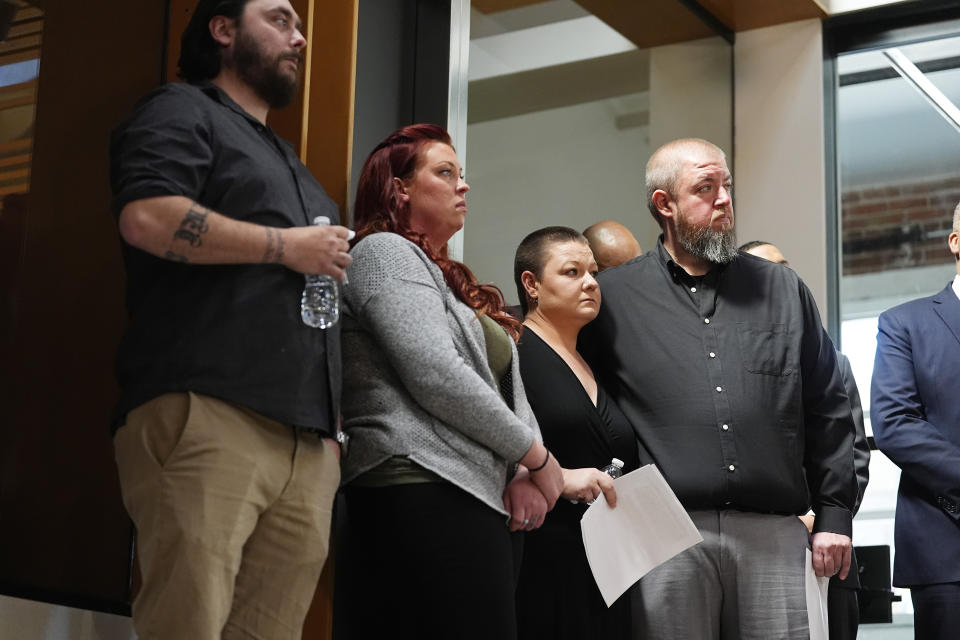 From left, Devon and Jess Vestal join Brittany Yarborough and her husband, Kevin, look on during a news conference to announce plans to sue the Littleton, Colo., school district for abuse suffered by their autistic children while riding the bus to class, Tuesday, April 9, 2024, in Denver. (AP Photo/David Zalubowski)