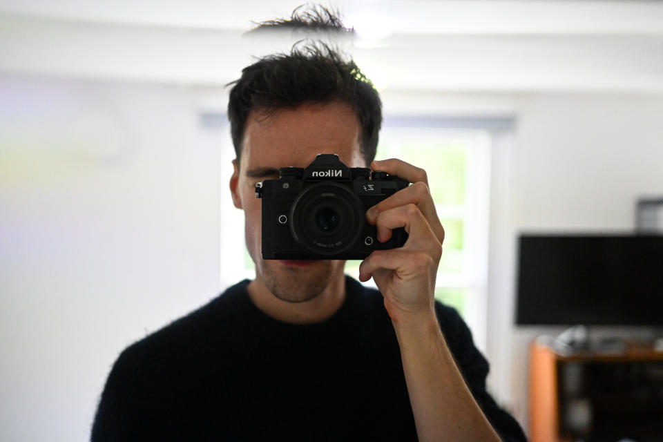 Selfie in a mirror with the camera covering a mans face