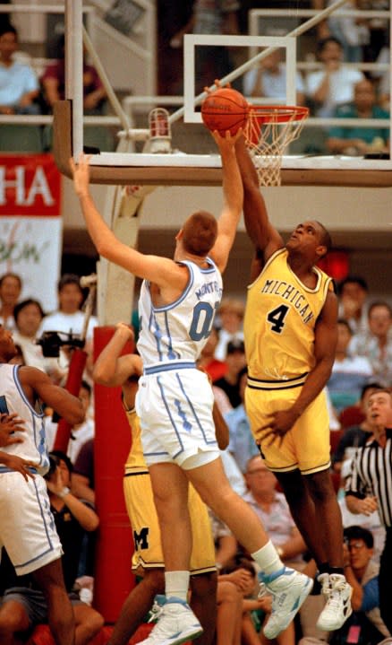Michigan’s Chris Webber, right, blocks a shot by North Carolina’s Eric Montross during action at the Rainbow Classic tournament in Honolulu December 29, 1992. Michigan and North Carolina will compete in the NCAA championship finals in New Orleans, April 4, 1993.