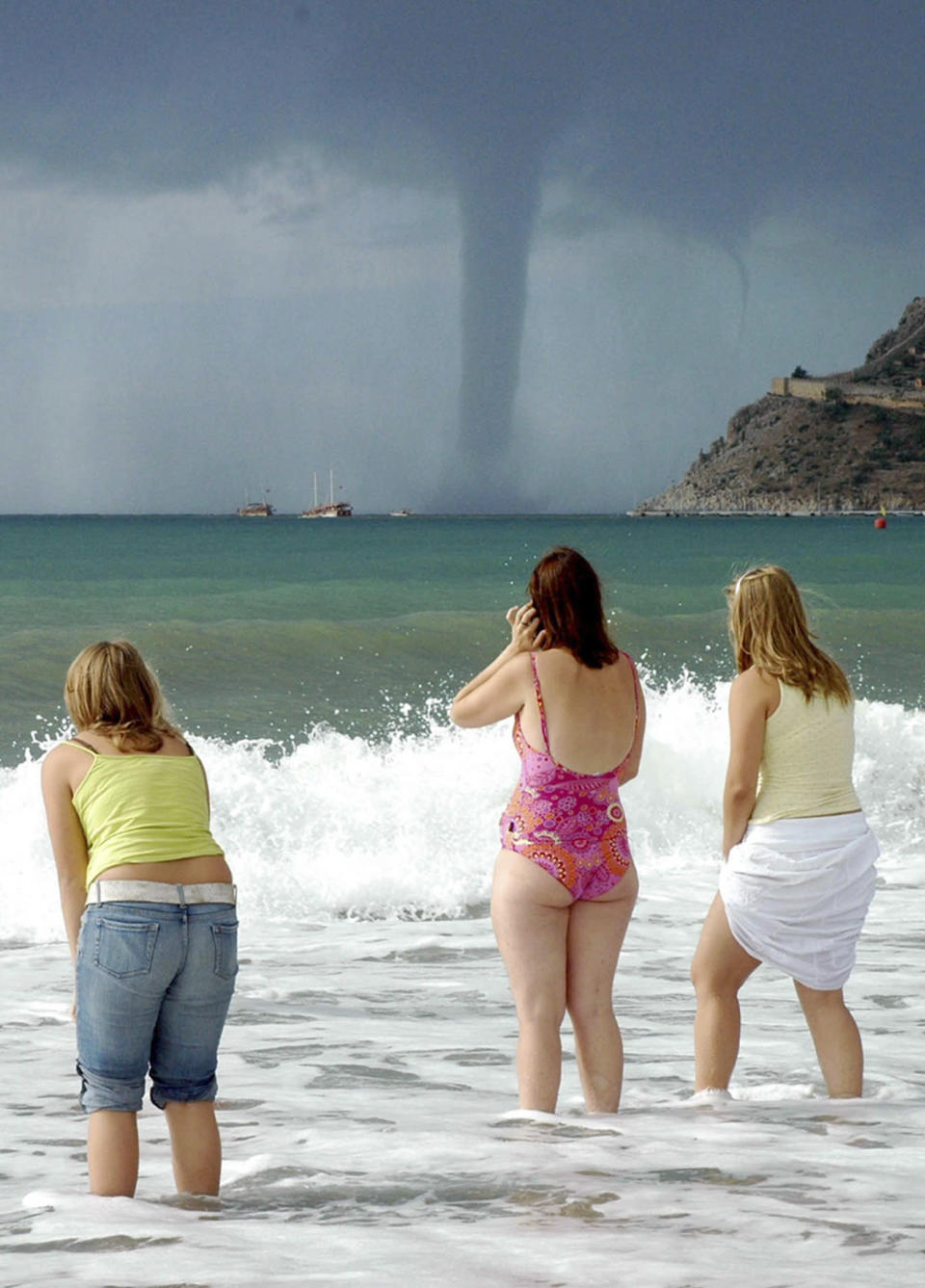 Tourists on the Mediterranean coastal city of Antalya watch a waterspout on the sea October 19, 2006. REUTERS/Anatolian