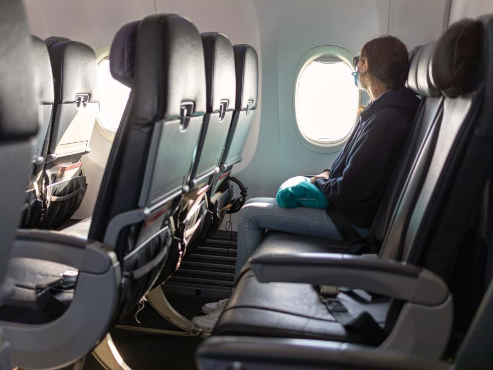 Passenger looking out airplane window