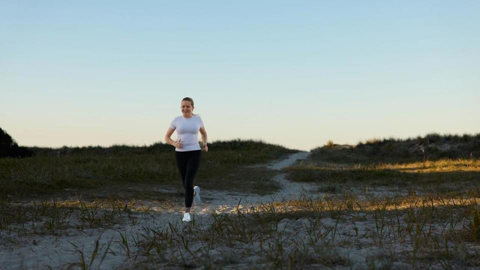 Fran Hurndall running on a beach