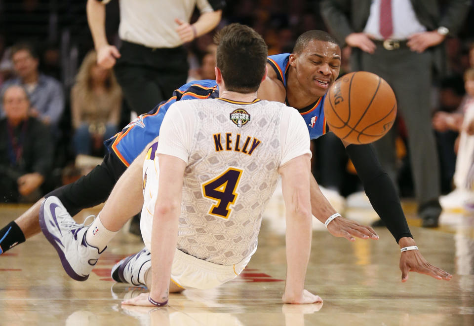 Oklahoma City Thunder point guard Russell Westbrook is called for an offensive foul and then a technical foul after colliding with Los Angeles Lakers power forward Ryan Kelly (4) during the first half of an NBA basketball game in Los Angeles, Sunday, March 9, 2014. (AP Photo/Danny Moloshok)