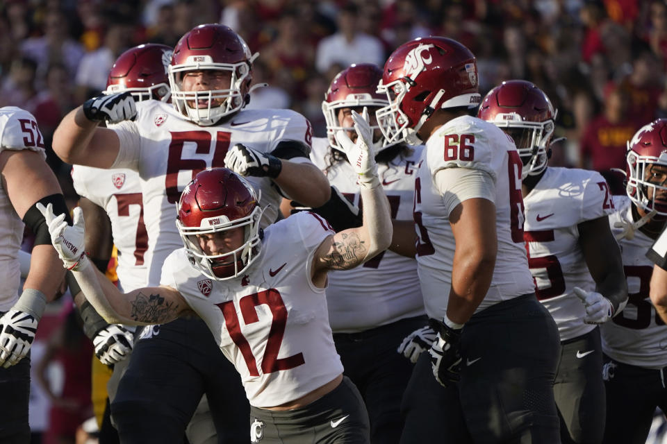 Washington State wide receiver Robert Ferrel (12) celebrates after catching a touchdown during the first half of an NCAA college football game against Southern California, Saturday, Oct. 8, 2022, in Los Angeles. (AP Photo/Marcio Jose Sanchez)