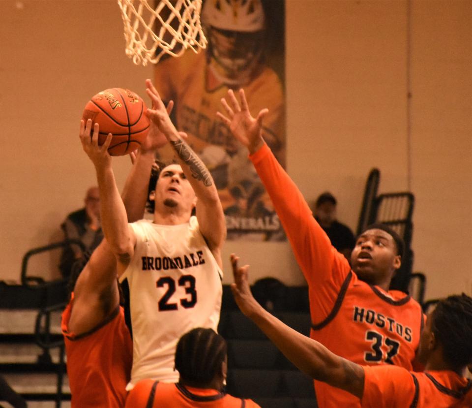 Adam Kukaj takes a shot for Brookdale Community College Wednesday while surrounded by Hostos Community College Caimans during a first round game in the NJCAA tournament in Herkimer.