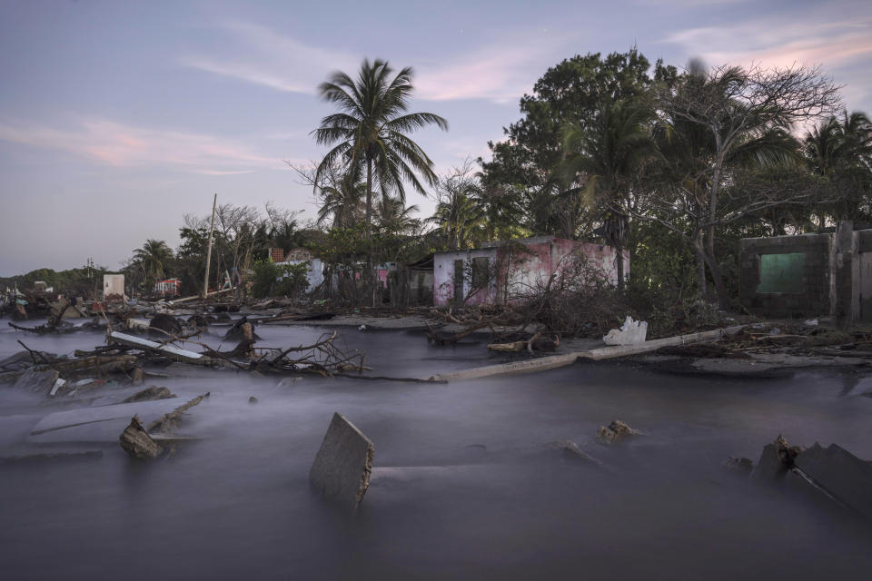 FILE - Debris from collapsed home and felled trees litter the shore line of the coastal community of El Bosque, in the state of Tabasco, Mexico, Nov. 30, 2023. Flooding driven by a sea-level rise and increasingly brutal winter storms destroyed the Mexican community. (AP Photo/Felix Marquez, File)