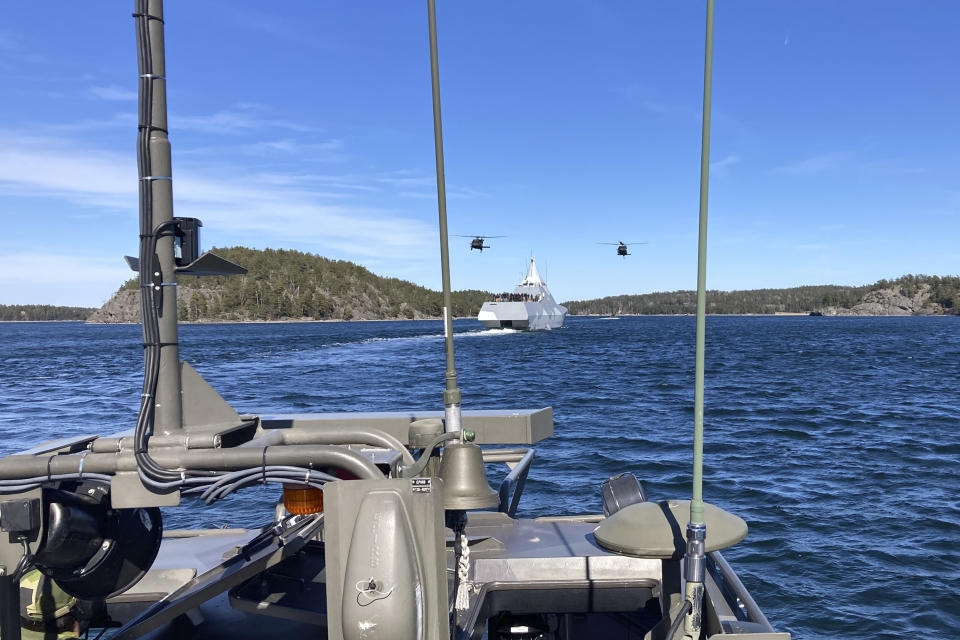 Swedish Black Hawk helicopters fly over the Navy ship that Defense Secretary Lloyd Austin travels on through the islands in the southern Stockholm archipelago Wednesday, April 19, 2023. Austin got to see several military demonstrations. (AP Photo/Lolita Baldor)