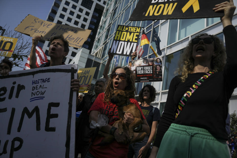 Families and supporters of Israeli hostages held by Hamas in Gaza hold banners and shut slogans during a protest calling for their return, outside a meeting between U.S. Secretary of State Antony Blinken and families of hostages in Tel Aviv, Wednesday, May 1, 2024. (AP Photo/Oded Balilty)