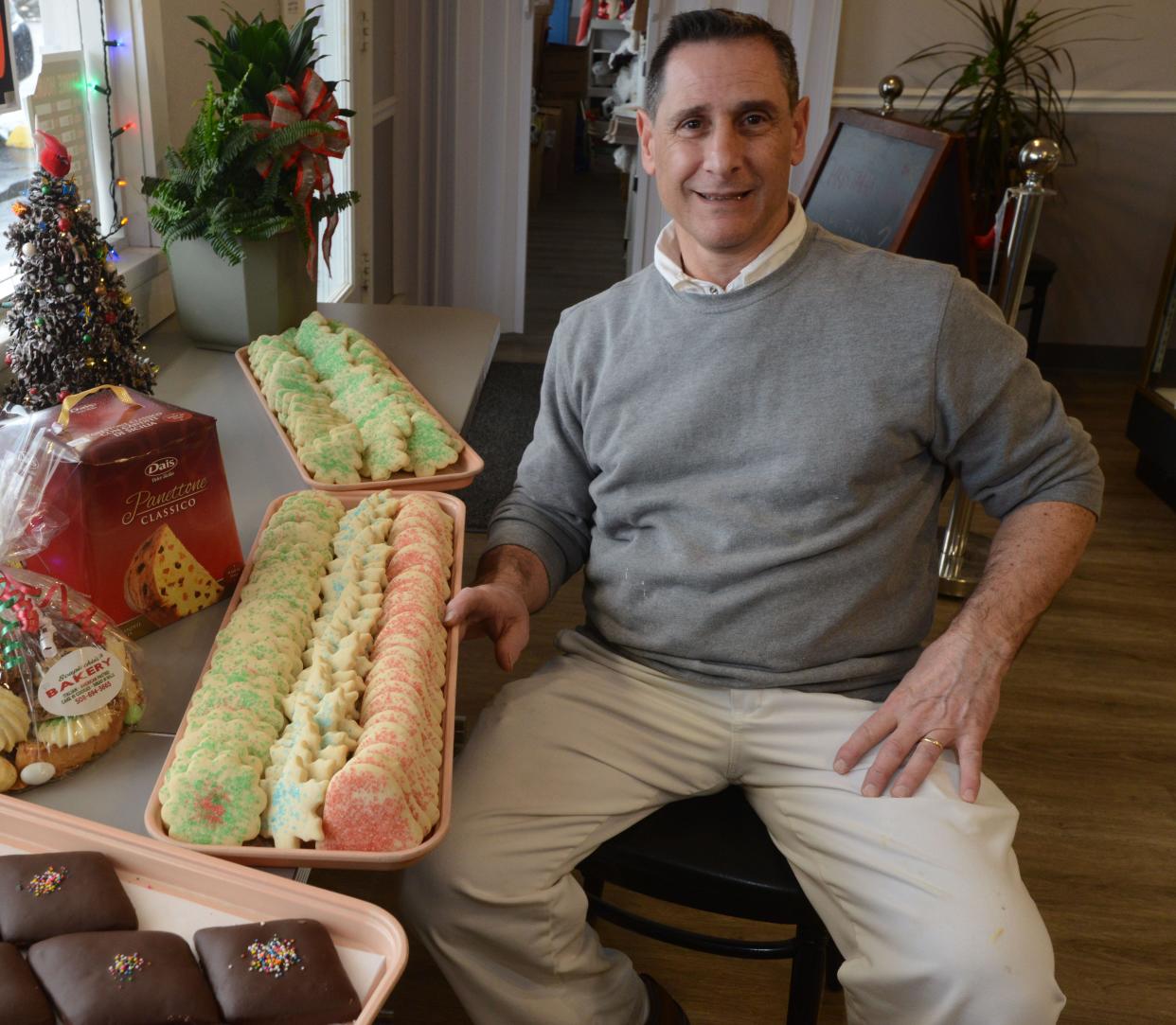 Matthew Scapicchio with his cookie creations in a 2021 file photo at Scapicchio's Bakery in South Yarmouth.