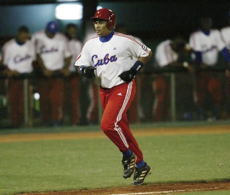 Cuban baseball player Frederich "Freddy" Cepeda scores a home run against South Korea, in the fourth inning of their elimination game at the 35th Baseball World Championships in Havana in this October 14, 2003 file photograph. REUTERS/Claudia Daut/Files