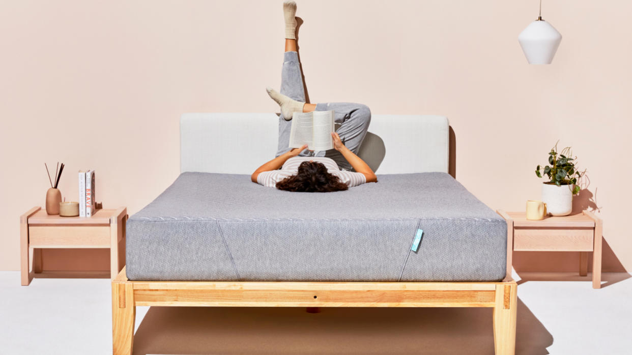  Siena memory foam mattress, featuring a person lying upside on the bed reading a book. 