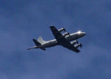 A U.S. P3 Orion surveillance aircraft is seen flying over the town of Marawi city, as government troops continue their assault against insurgents from the Maute group, who has taken over large parts of the city, Philippines June 9, 2017. REUTERS/Romeo Ranoco