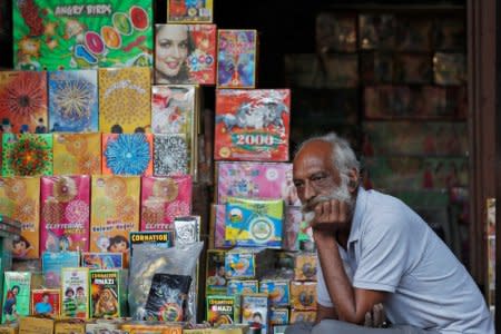 A shopkeeper waits for customers at his firecracker shop in the old quarters of Delhi, India, October 17, 2018. Picture taken October 17, 2018. REUTERS/Adnan Abidi