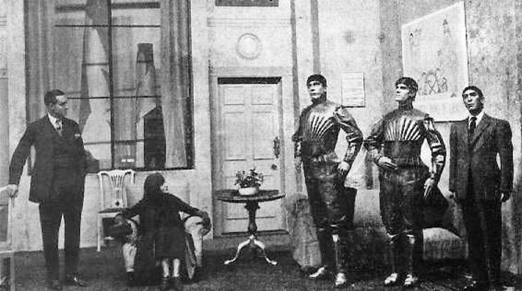 A black and white image of three robots, a woman and a man.