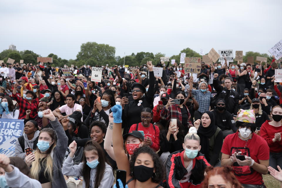 LONDON, ENGLAND - JUNE 03: Protesters wearing face masks, hold up placards and raise clenched fists during a Black Lives Matter protest in Hyde Park on June 3, 2020 in London, United Kingdom. The death of an African-American man, George Floyd, while in the custody of Minneapolis police has sparked protests across the United States, as well as demonstrations of solidarity in many countries around the world. (Photo by Dan Kitwood/Getty Images)