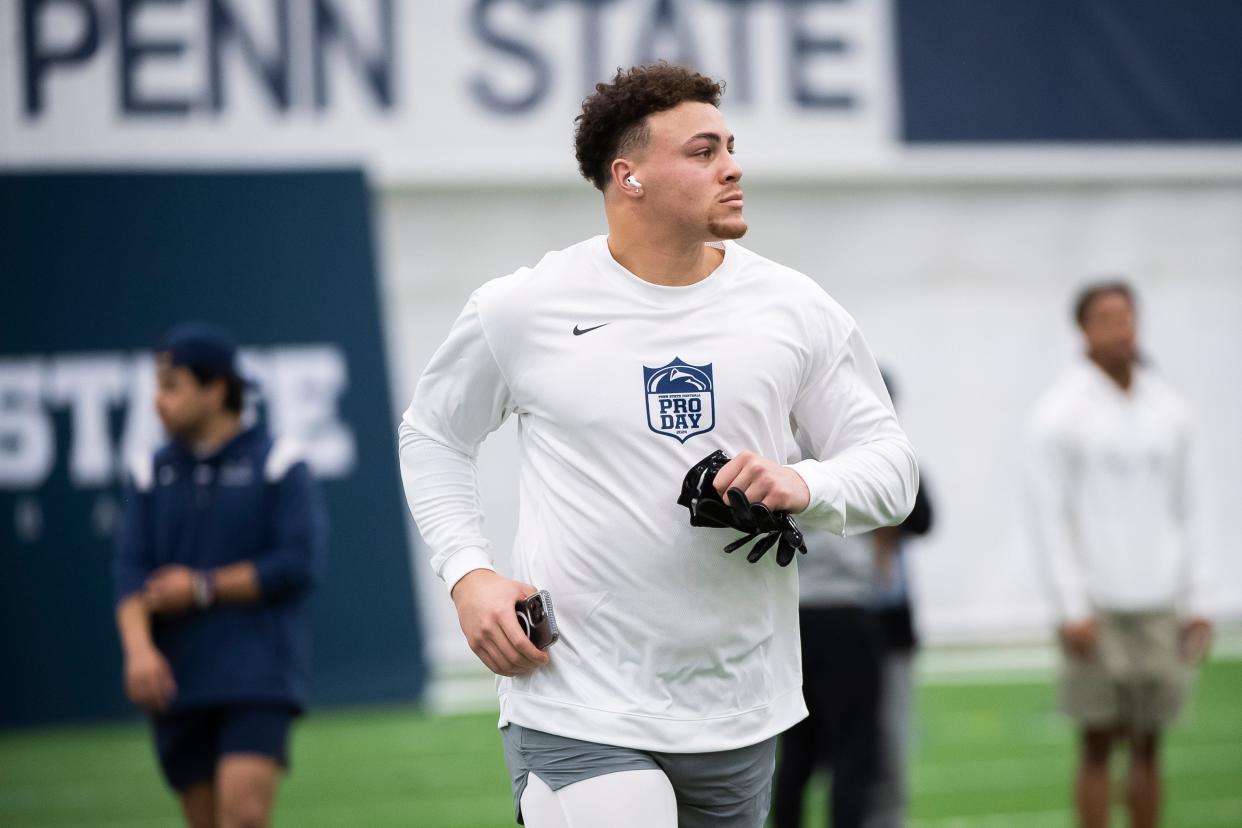 Tight end Theo Johnson jogs onto the field to run a drill during Penn State's Pro Day in Holuba Hall on March 15, 2024, in State College.