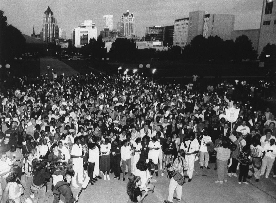 Hundreds of people gather at MacArthur Square in Milwaukee, Aug. 6, 1991 as they held a candlelight vigil in remembrance of the victims found in the Jeffrey L. Dahmer apartment on July 22.