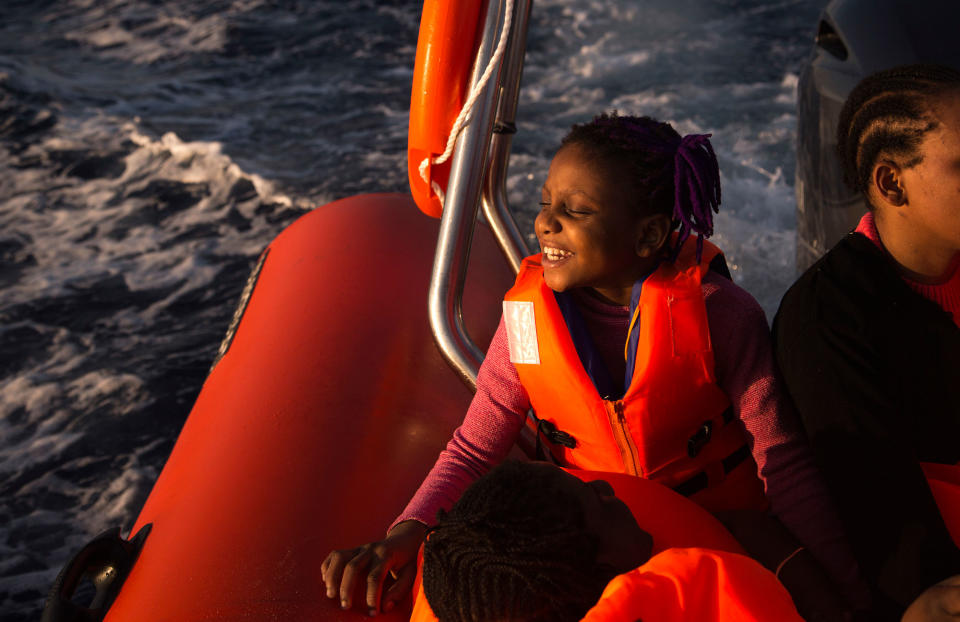 <p>Sira, 9, from Nigeria, smiles sailing aboard the RIB boat of Proactiva Open Arms NGO, after being rescued during an operation at the Mediterranean sea, about 17 miles north of Sabratah, Libya, Saturday, Aug. 20, 2016. Migrants seemingly prefer to face the dangers of the journey towards Europe, rather than stay at home. (AP Photo/Emilio Morenatti) </p>