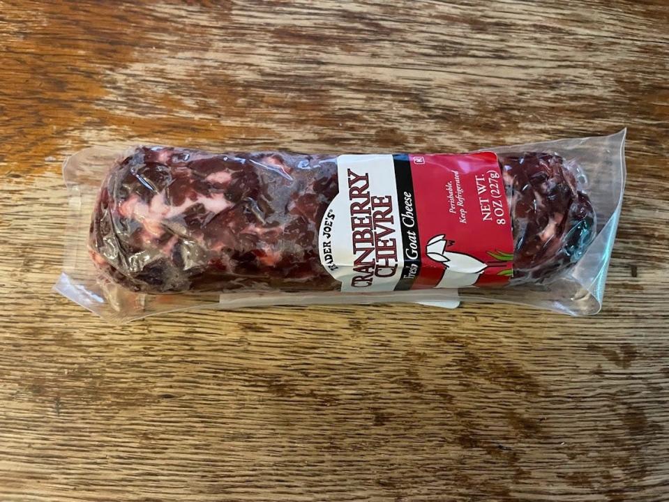 Clear package of Trader Joe's cranberry chevre on wooden counter