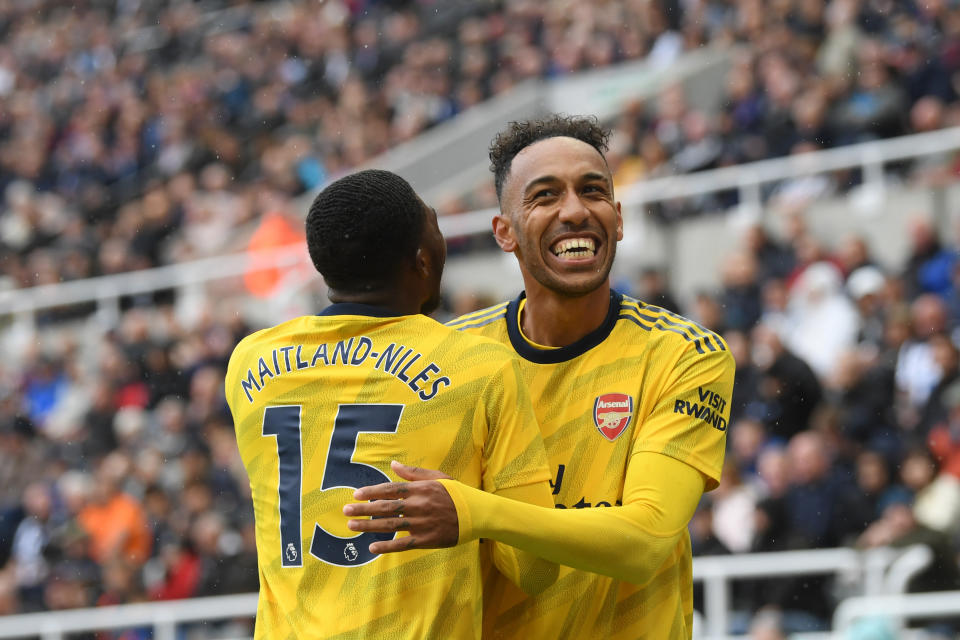Aubameyang celebrates with teammate Ainsley Maitland-Niles after scoring at St. James Park. (Photo by Stu Forster/Getty Images)