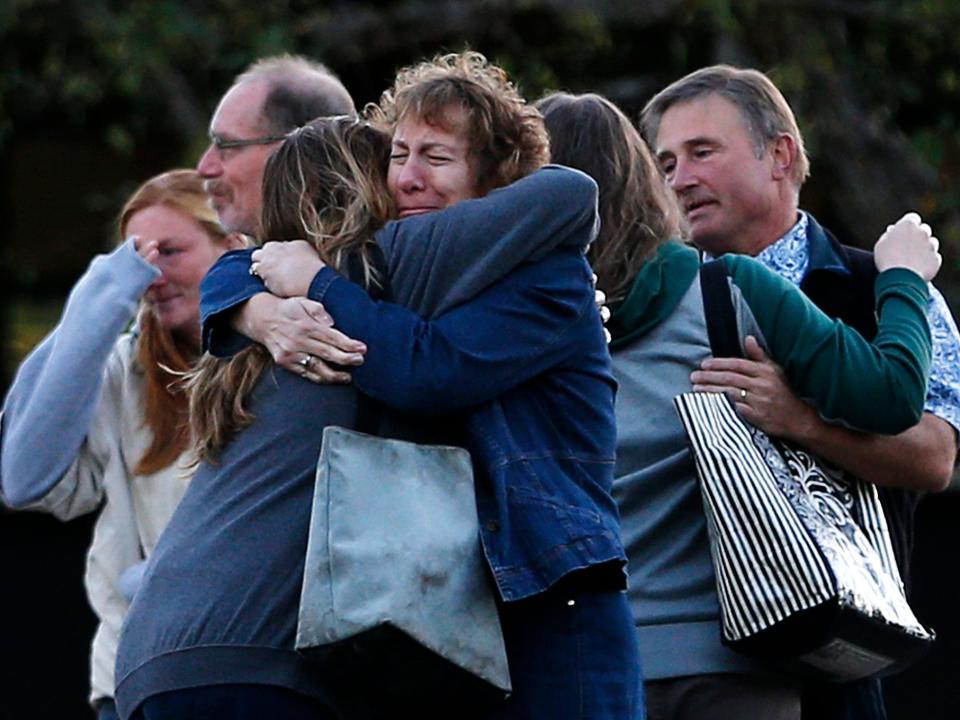 Faculty members embrace on their return to Umpqua Community College in Roseburg, Oregon.