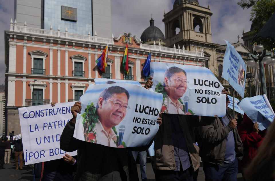 FILE - Supporters of Bolivian President Luis Arce hold signs that read in Spanish, "Lucho you are not alone" during a march in support of the government, in La Paz, Bolivia, June 17, 2024. Arce and his one-time ally, former President Evo Morales, are battling for the future of Bolivia's splintering Movement for Socialism ahead of elections in 2025. (AP Photo/Juan Karita, File)
