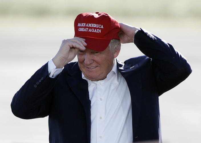 FILE - In this June 1, 2016, file photo, Republican presidential candidate Donald Trump wears his "Make America Great Again" hat at a rally in Sacramento, Calif. Donald Trump enters the White House on Jan. 20 just as he entered the race for president: defiant, unfiltered, unbound by tradition and utterly confident in his chosen course. In the 10 weeks since his surprise election as the nation’s 45th president, Trump has violated decades of established diplomatic protocol, sent shockwaves through business boardrooms, tested long-standing ethics rules and continued his combative style of replying to any slight with a personal attack _ on Twitter and in person. (AP Photo/Jae C. Hong, File)