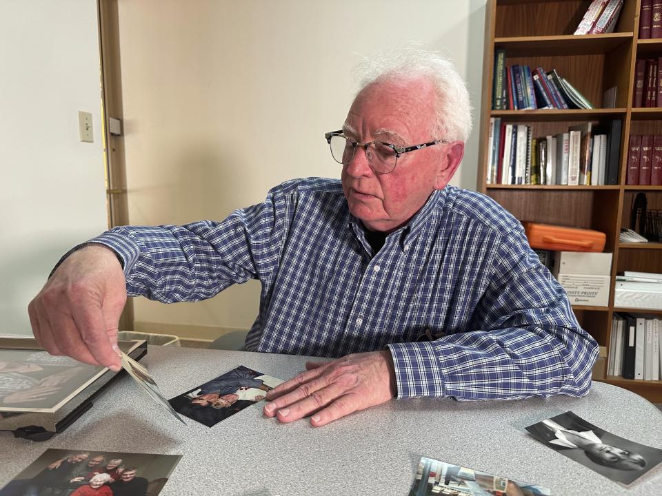 Michael Kruzich looks at a photo of his late mother Donna, Monday, April 15, 2024, in Lansing, Mich. Donna Kruzich was one of dozens of people in the U.S. who died after being injected with tainted steroids made by a specialty pharmacy in Massachusetts. Now, more than a decade later, the operator of the New England Compounding Center is returning to a Michigan court to be sentenced on involuntary manslaughter charges. (AP Photo/Mike Householder)