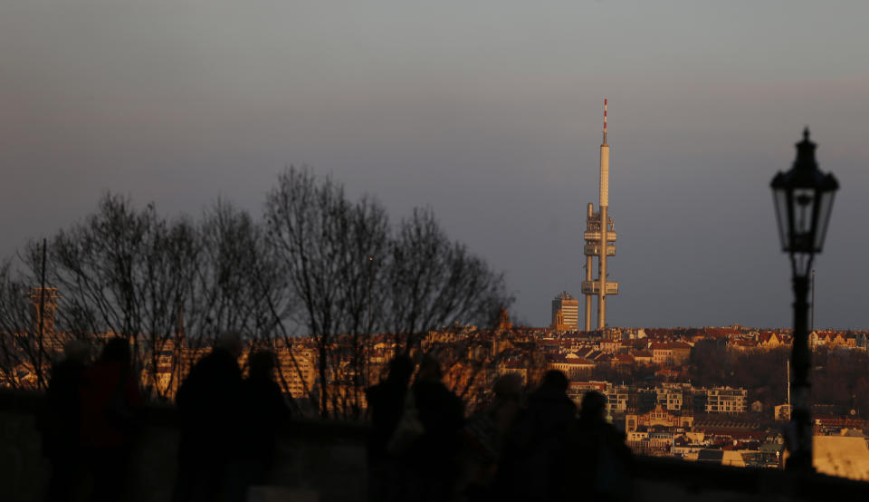 This picture taken March 6, 2013 shows the Zizkov television tower peaking over the skyline of Prague, Czech Republic. Following its completion in 1992, the 216-meter (236-yard) tall television tower in the Czech capital has become a dominant landmark of the city skyline that offers a breathtaking view of Prague from its restaurant and observation desk. (AP Photo/Petr David Josek)