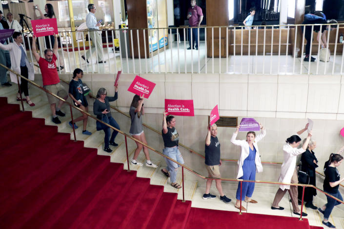 Abortion rights protesters are removed after becoming vocal, Tuesday, May 16, 2023, in Raleigh, N.C., after North Carolina House members voted to override Democratic Gov. Roy Cooper's veto of a bill that would change the state's ban on nearly all abortions from those after 20 weeks of pregnancy to those after 12 weeks of pregnancy. Both the Senate and House had to complete successful override votes for the measure to be enacted into law. The Senate voted to override the veto earlier, and the House also voted to override. (AP Photo/Chris Seward)