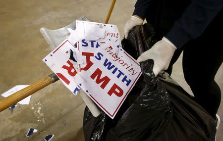 Members of the cleaning crew sweep the floor at the UIC Pavilion after Republican U.S. presidential candidate Donald Trump cancelled his rally for safety reasons at the University of Illinois at Chicago March 11, 2016. REUTERS/Kamil Krzaczynski